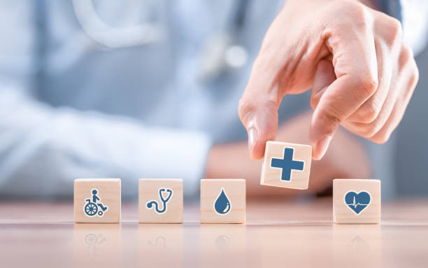 istockphoto-1204151313-612×612 Hand arranging wood block with healthcare medical icon. Health insurance - concept.